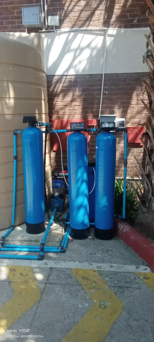 Water filtration system with blue tanks and pipes