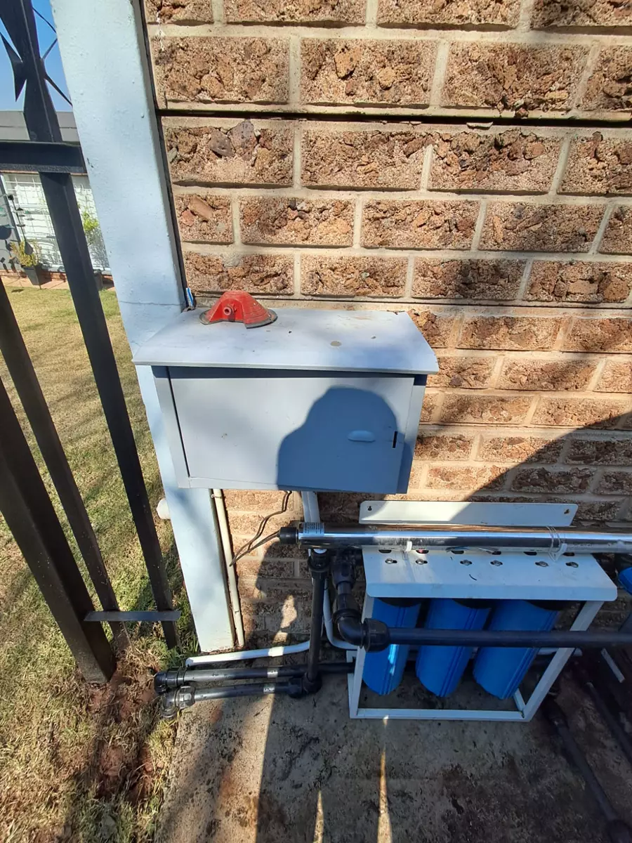 Outdoor water filtration system and utility box mounted on a wall