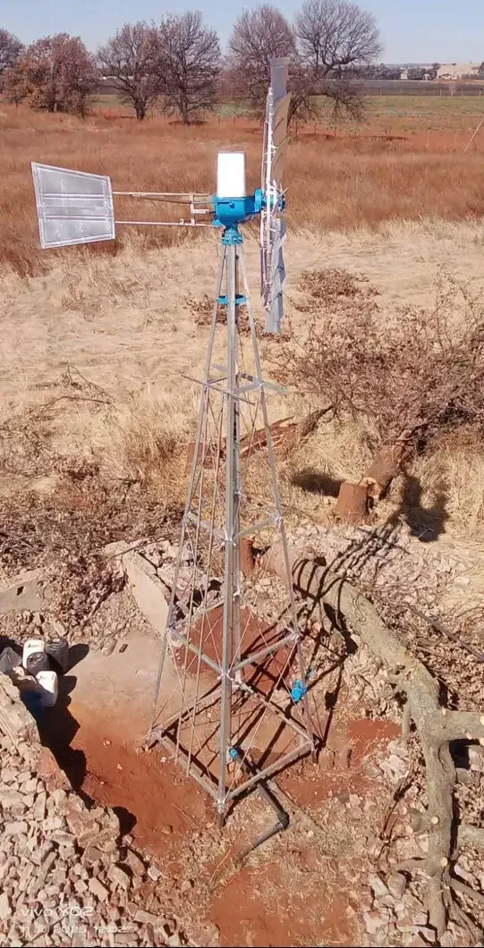 Metal windmill tower in a field
