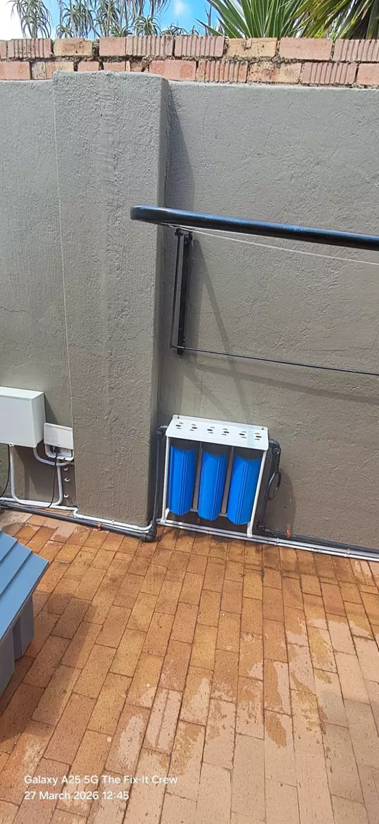 Water filtration system mounted on a rendered wall